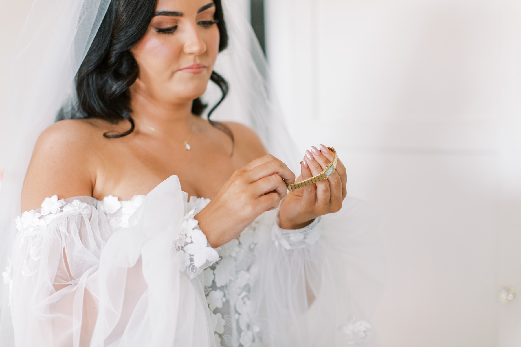 A bride adjusting her veil at Glewstone Court