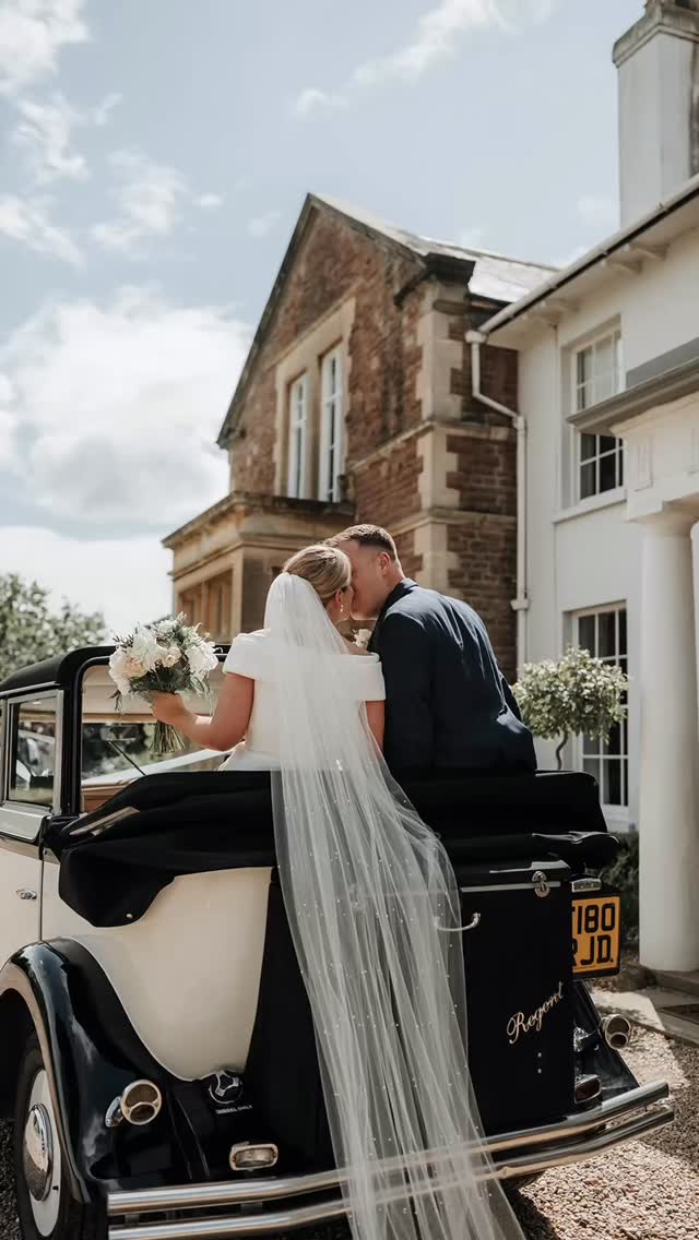 A couple leaving Glewstone Court by vintage car